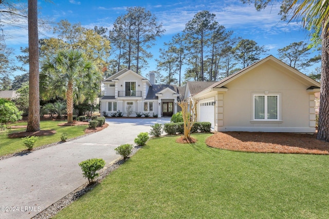 front of property with a garage and a front lawn