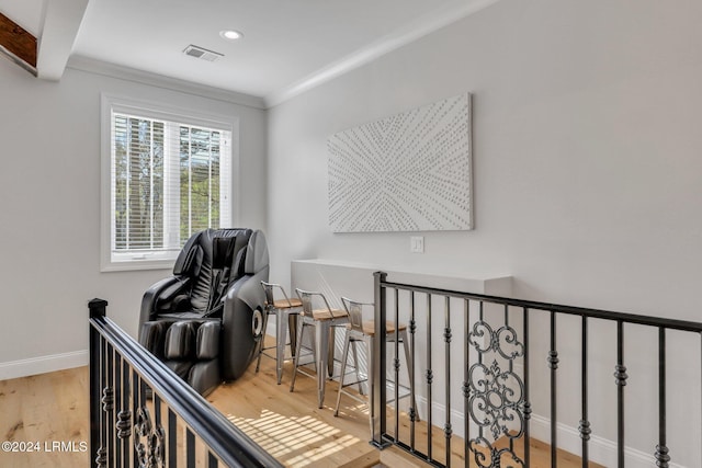 interior space with crown molding and light hardwood / wood-style floors