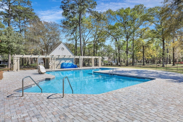 view of swimming pool with a pergola and a patio area