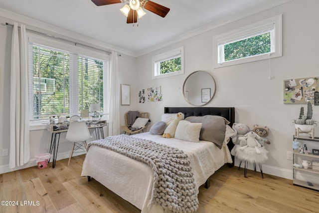 bedroom featuring ceiling fan, ornamental molding, and light hardwood / wood-style floors