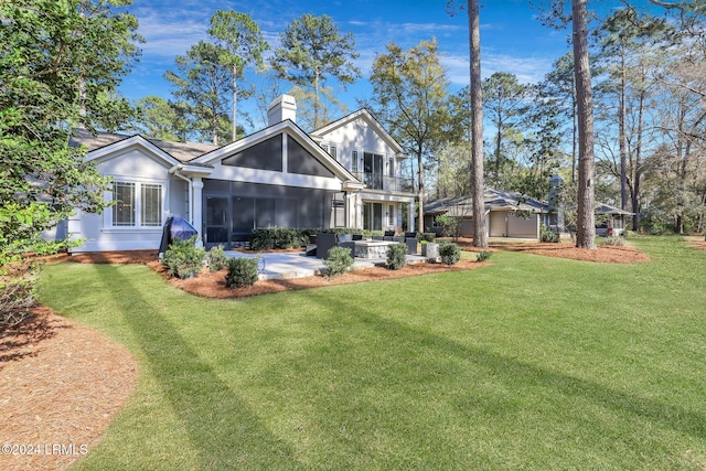 back of house featuring a balcony, a yard, and a patio