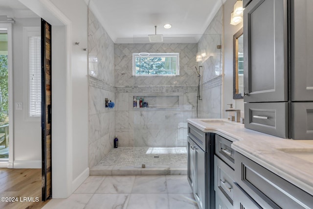 bathroom with vanity and tiled shower