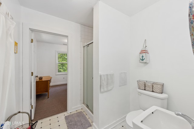 full bath featuring tile patterned floors, baseboards, and a stall shower