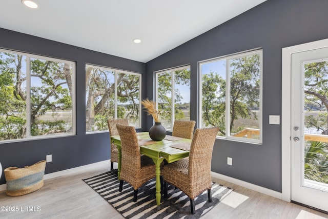 dining area with recessed lighting, baseboards, lofted ceiling, and light wood-style flooring