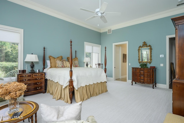 bedroom featuring ornamental molding, light carpet, and ceiling fan