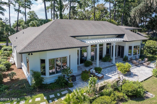 back of property featuring a patio and a pergola