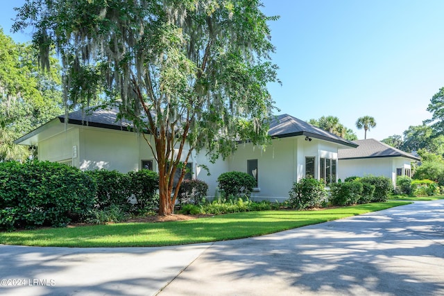 view of property exterior with a lawn