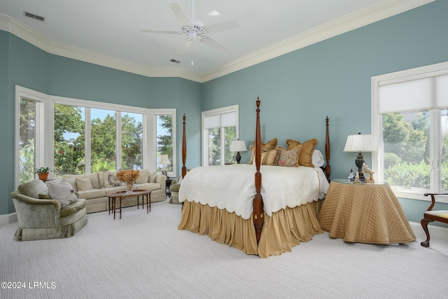 bedroom with ceiling fan, ornamental molding, and carpet