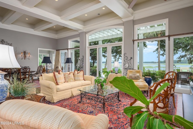 living room featuring beamed ceiling, a water view, ornamental molding, and coffered ceiling