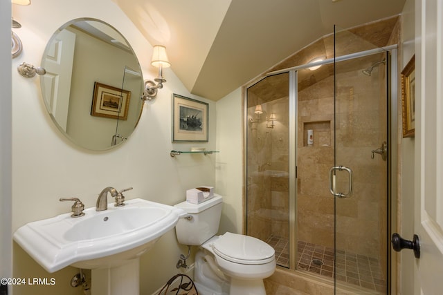 bathroom with vaulted ceiling, sink, an enclosed shower, and toilet