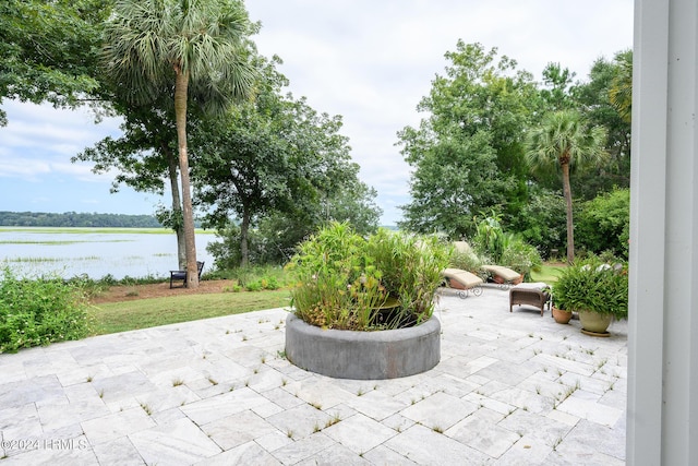 view of patio with a water view