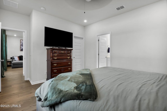 bedroom with hardwood / wood-style flooring and ceiling fan