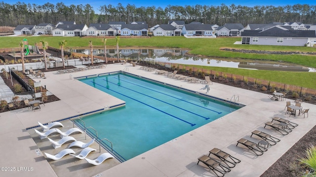 view of pool with a patio and a lawn