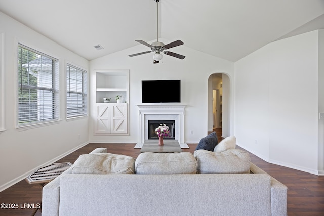 1470 Ashley Gardens Blvd, Charleston, SC 29414 - living room featuring arched walkways, built in shelves, a ceiling fan, dark wood-style floors, and vaulted ceiling