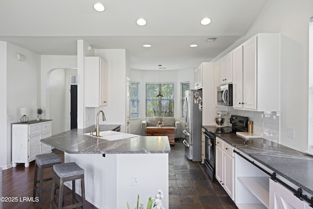 1470 Ashley Gardens Blvd, Charleston, SC 29414 - kitchen with appliances with stainless steel finishes, a sink, white cabinetry, a breakfast bar area, and recessed lighting