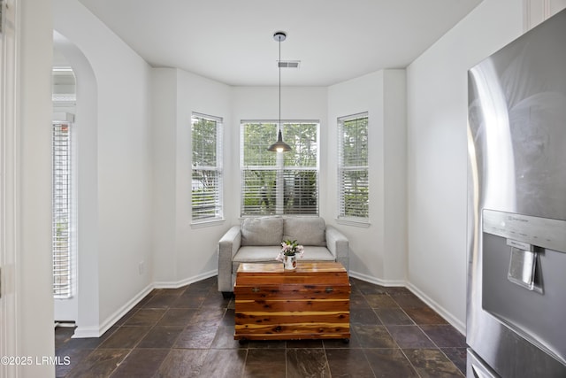 1470 Ashley Gardens Blvd, Charleston, SC 29414 - sitting room featuring arched walkways, baseboards, and dark stone finish floors