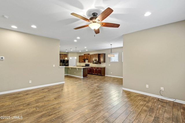 59 Gatewood Ln, Bluffton, SC 29910 - unfurnished living room with ceiling fan, dark wood finished floors, and recessed lighting