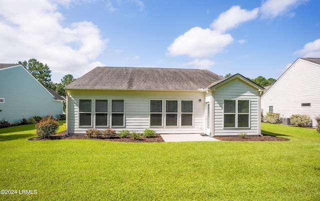 back of property featuring central AC, a lawn, and a patio area