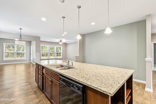 59 Gatewood Ln, Bluffton, SC 29910 - kitchen featuring dishwasher, open floor plan, light wood-style floors, decorative light fixtures, and a kitchen island with sink