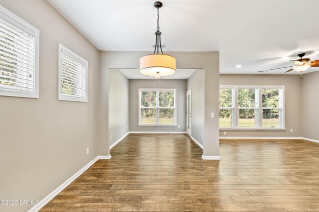 59 Gatewood Ln, Bluffton, SC 29910 - kitchen with black fridge, light wood-style floors, tasteful backsplash, and light stone countertops