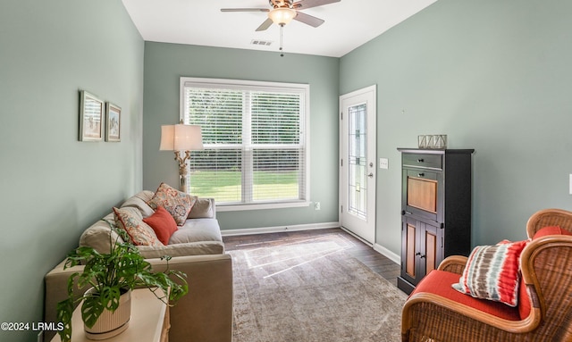 living room featuring wood-type flooring and ceiling fan