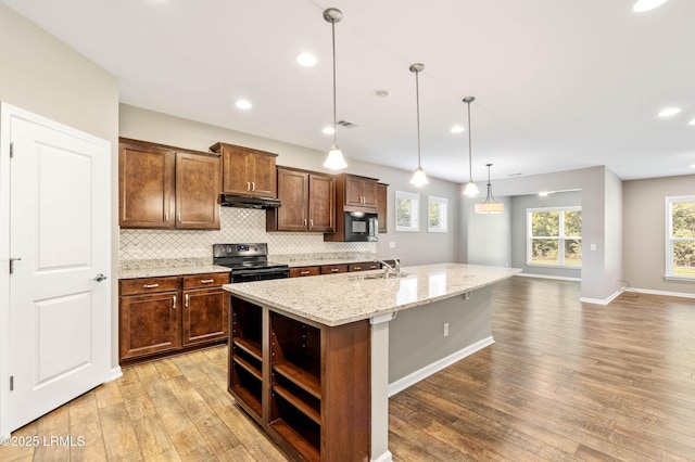 59 Gatewood Ln, Bluffton, SC 29910 - kitchen with black electric range oven, under cabinet range hood, built in microwave, open shelves, and light wood-style flooring