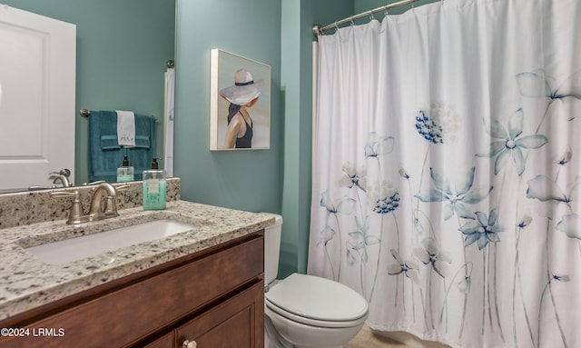 bathroom featuring vanity, toilet, and walk in shower