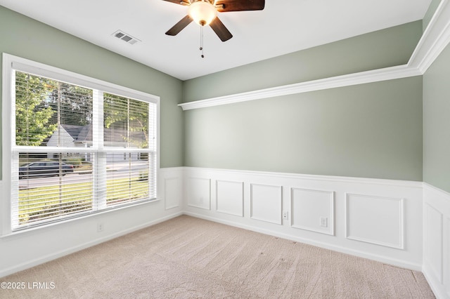 59 Gatewood Ln, Bluffton, SC 29910 - spare room with a ceiling fan, light carpet, and a wainscoted wall