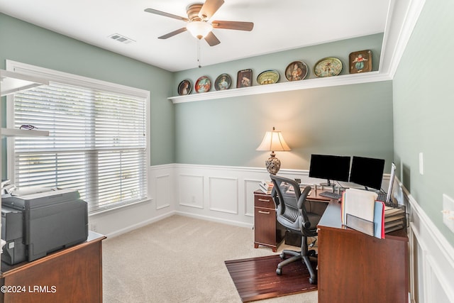 office with a healthy amount of sunlight, light colored carpet, and ceiling fan