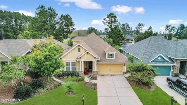 craftsman house featuring a garage and a front yard