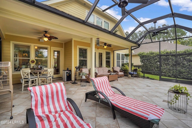 view of patio with outdoor lounge area, ceiling fan, and glass enclosure