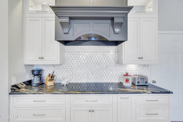 kitchen featuring white cabinetry, custom range hood, and decorative backsplash