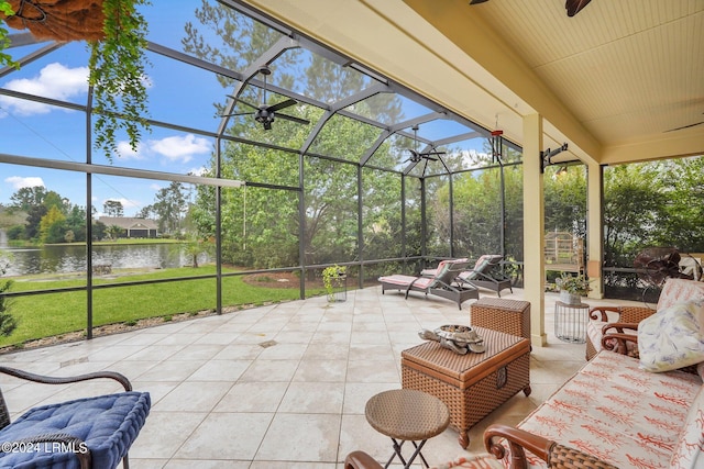 view of patio / terrace featuring a water view, ceiling fan, a lanai, and outdoor lounge area