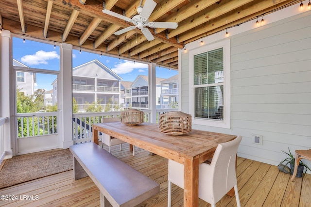 sunroom with beamed ceiling, ceiling fan, plenty of natural light, and wood ceiling