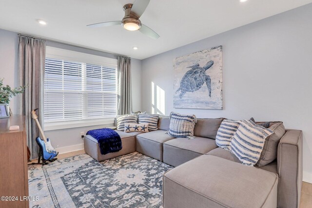 living room featuring light wood-type flooring and ceiling fan