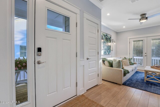 entryway featuring french doors, ceiling fan, and light wood-type flooring