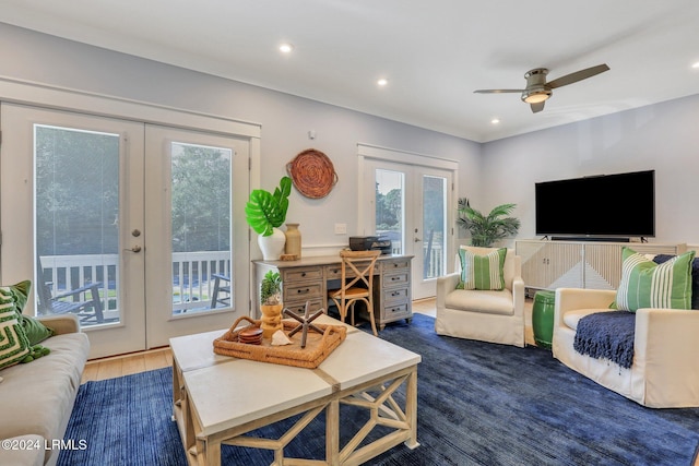 living room with dark hardwood / wood-style floors, french doors, and ceiling fan