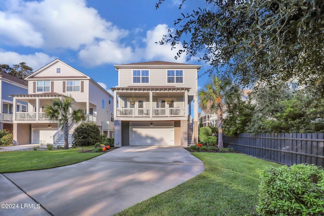 view of front of house with a garage, a porch, and a front yard