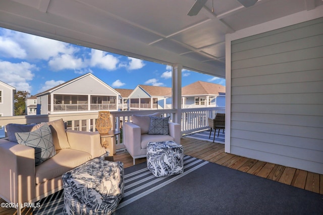 wooden terrace with ceiling fan and an outdoor hangout area