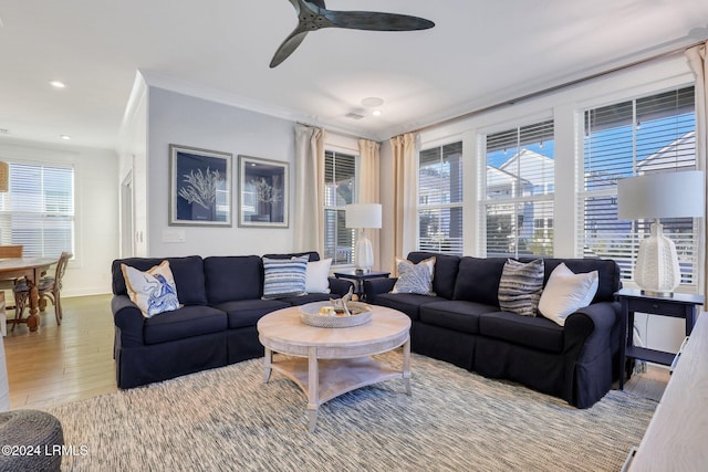 living room featuring ceiling fan, ornamental molding, hardwood / wood-style floors, and a wealth of natural light