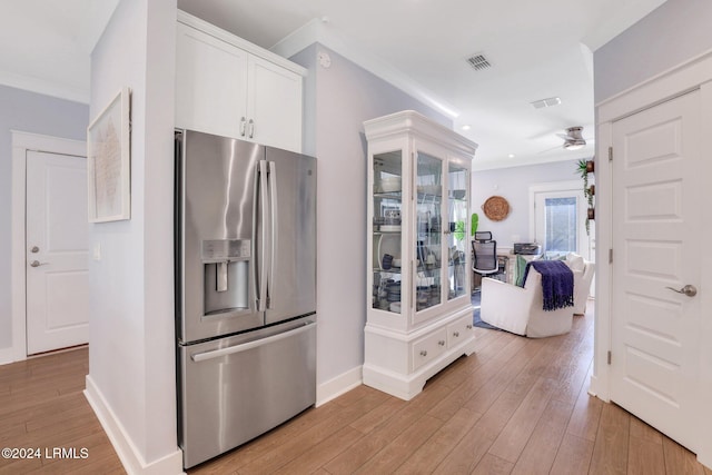 kitchen featuring stainless steel refrigerator with ice dispenser, ceiling fan, white cabinets, and light wood-type flooring