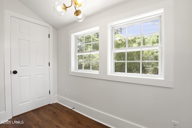1809 Battery Park Dr, Port Royal, SC 29935 - unfurnished bedroom with a chandelier, lofted ceiling, dark wood-style flooring, and baseboards