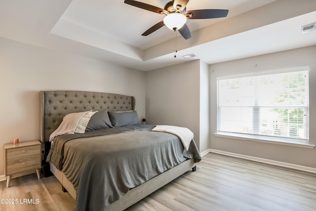 83 Plumgrass St, Bluffton, SC 29910 - bedroom featuring wood finished floors, a raised ceiling, and ceiling fan