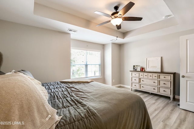 83 Plumgrass St, Bluffton, SC 29910 - bedroom with a tray ceiling, light wood finished floors, and a ceiling fan