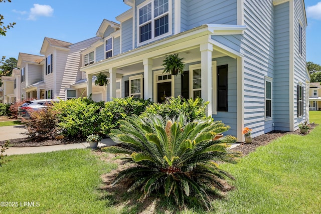 83 Plumgrass St, Bluffton, SC 29910 - view of side of property with a yard and a porch
