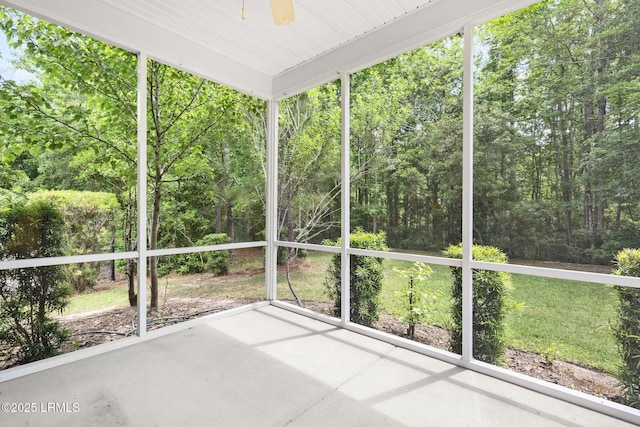 unfurnished sunroom featuring a ceiling fan