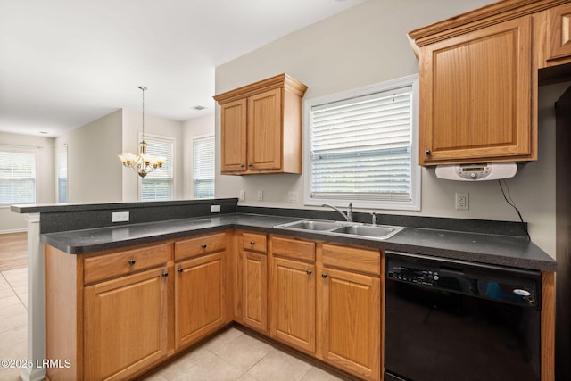 kitchen featuring dark countertops, a notable chandelier, a sink, black dishwasher, and a peninsula