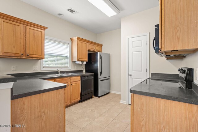 kitchen featuring visible vents, a sink, black appliances, and dark countertops