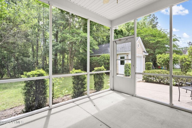 unfurnished sunroom featuring a ceiling fan