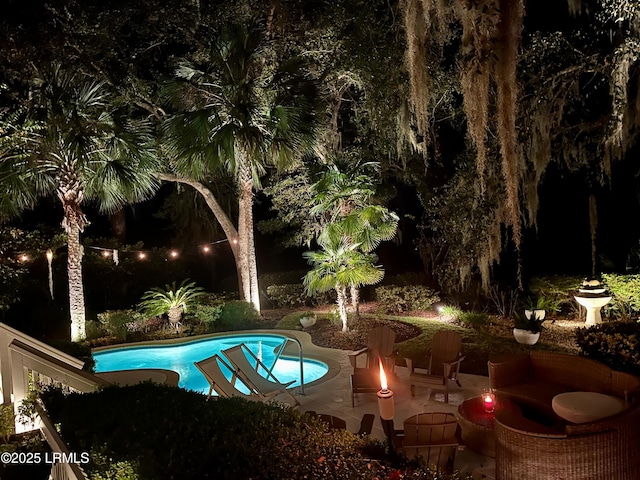 pool at twilight with an outdoor fire pit, an outdoor pool, and a patio